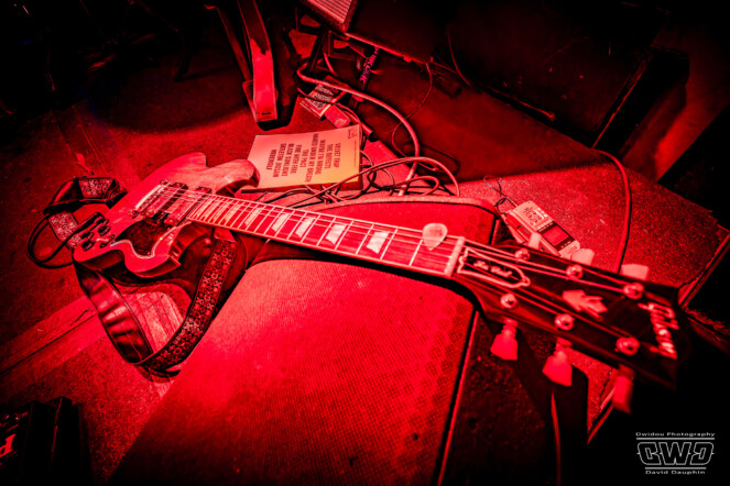 Guitars before, during and after show on their stands, waiting to be played